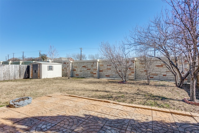 view of yard featuring a storage shed and a patio