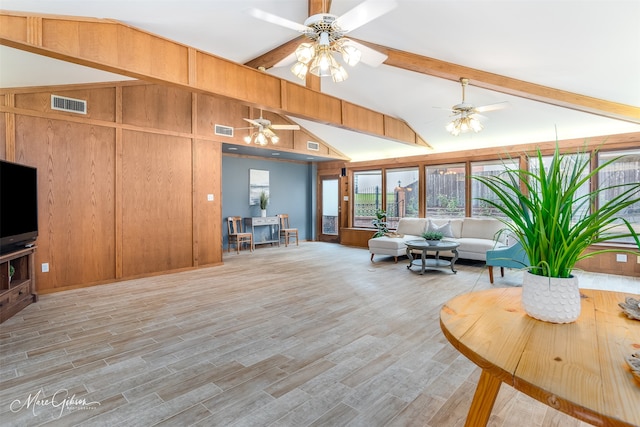 living room featuring light hardwood / wood-style floors, vaulted ceiling with beams, wood walls, and ceiling fan