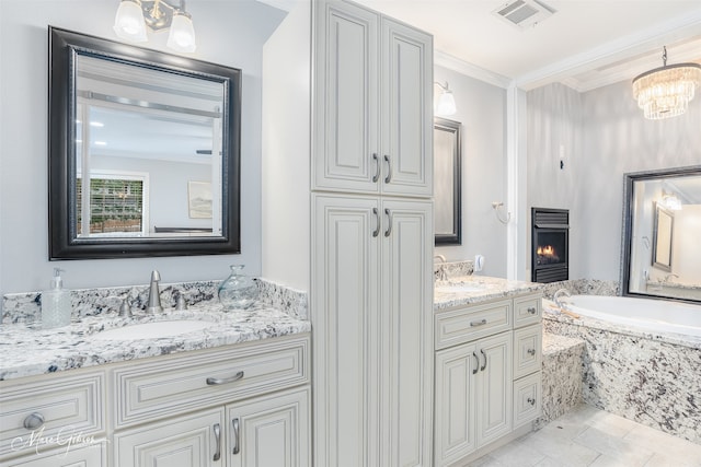 bathroom featuring vanity, a notable chandelier, a large fireplace, crown molding, and tile patterned floors