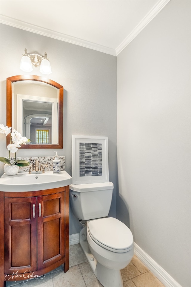 bathroom featuring toilet, vanity, tile patterned flooring, and crown molding