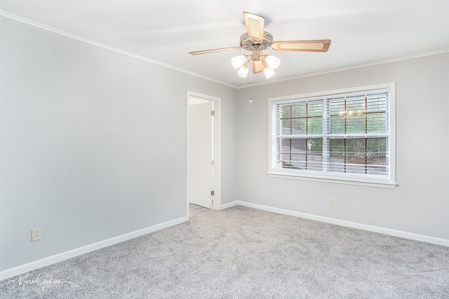 carpeted empty room with crown molding and ceiling fan