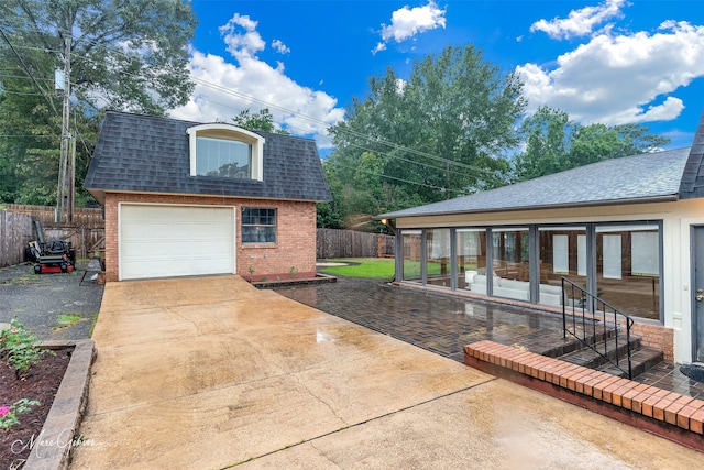 exterior space with a garage and an outdoor structure