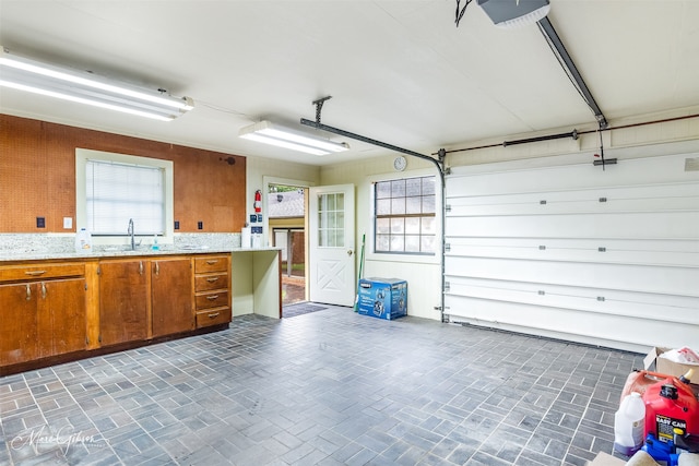 garage featuring a garage door opener and sink