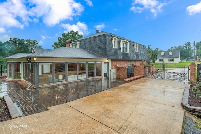 rear view of property featuring a patio