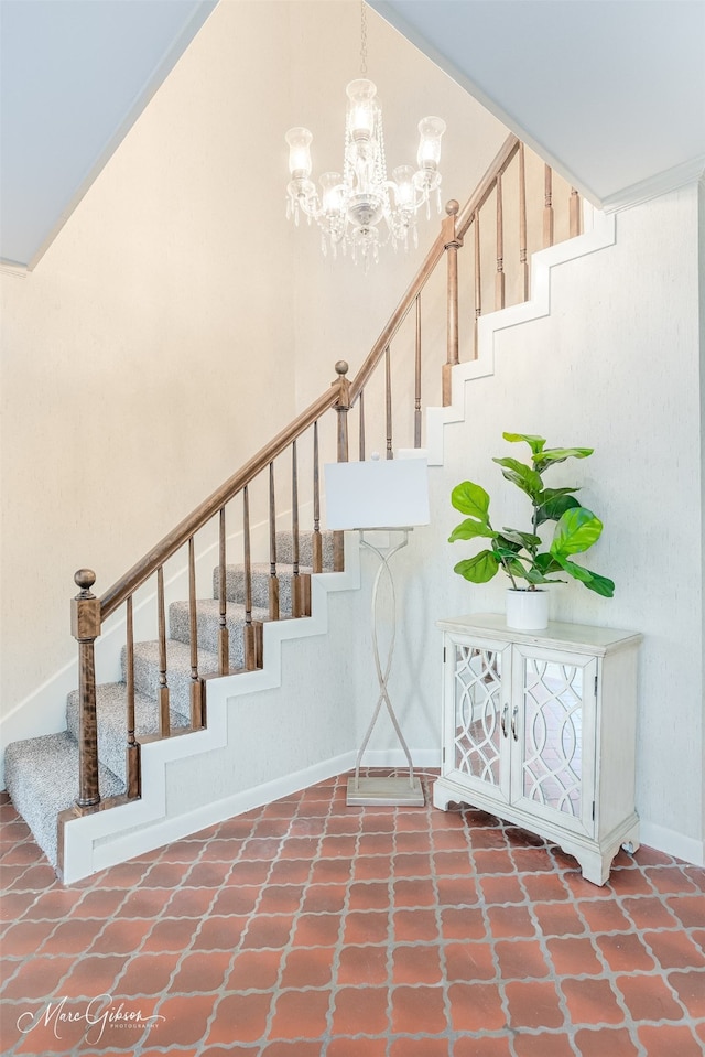 stairs featuring an inviting chandelier