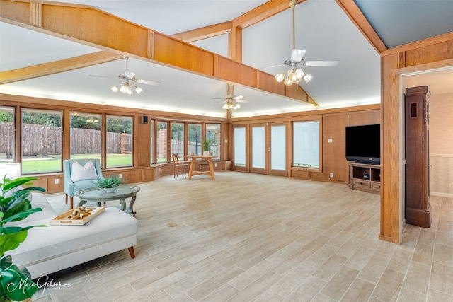 living room with light hardwood / wood-style floors, high vaulted ceiling, beamed ceiling, and wooden walls