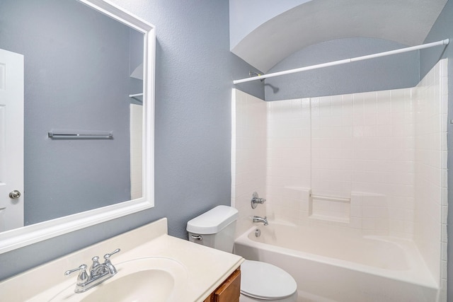 bathroom with  shower combination, a textured wall, toilet, and vanity