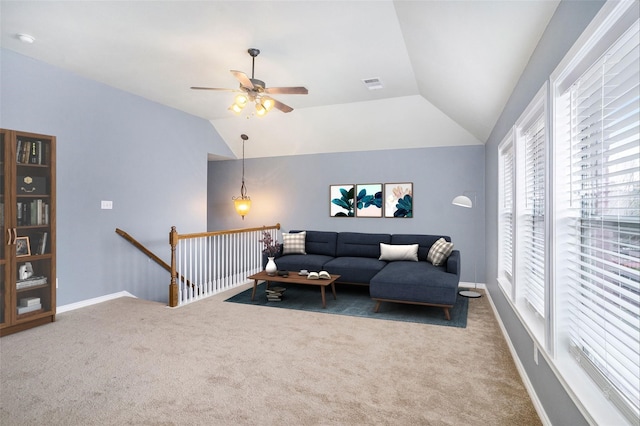 living room featuring baseboards, visible vents, a ceiling fan, vaulted ceiling, and carpet flooring