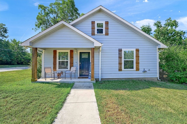 bungalow with a front yard and a porch