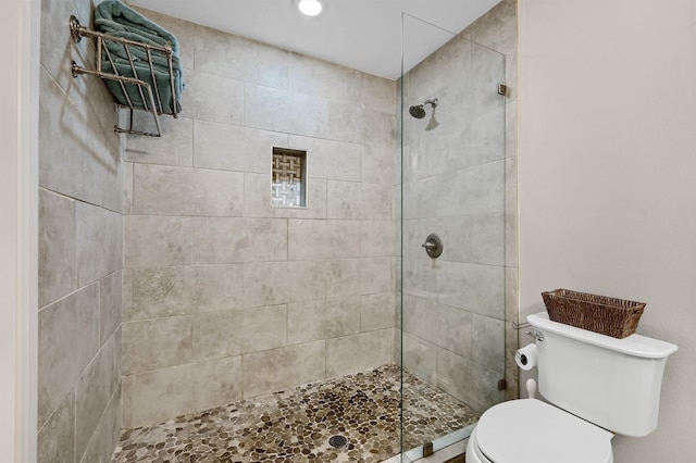 bathroom featuring toilet and tiled shower