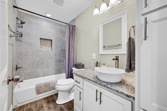 full bathroom with shower / tub combo with curtain, toilet, vanity, and wood-type flooring