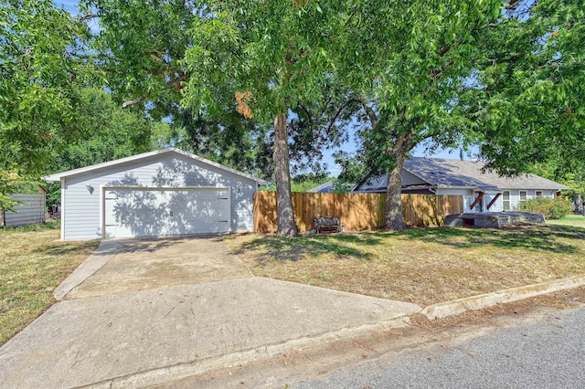 ranch-style house with a front yard, an outdoor structure, and a garage