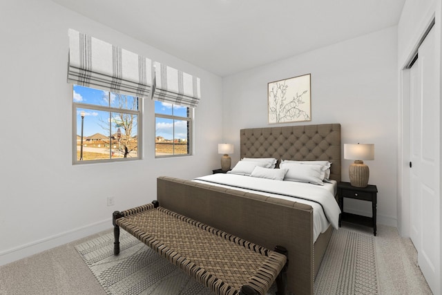 bedroom featuring light colored carpet and a closet