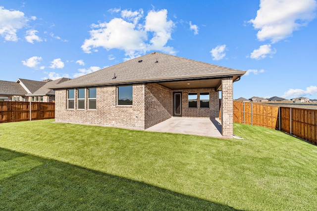 back of house featuring a patio area and a lawn