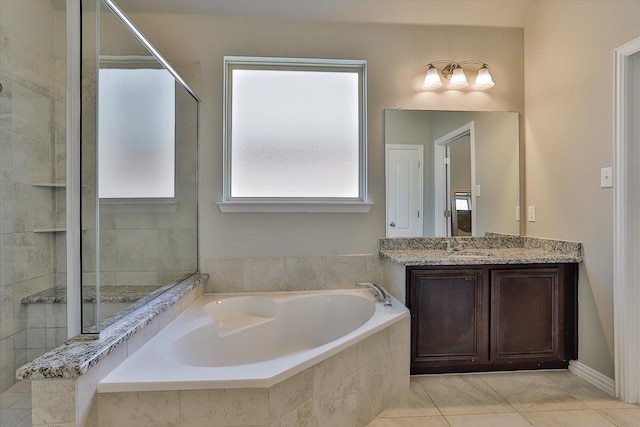 bathroom with tile patterned flooring, vanity, and plus walk in shower