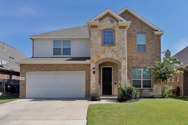 view of front of house featuring a front yard and a garage