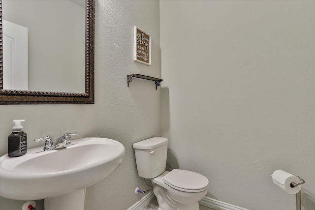 bathroom featuring toilet and sink