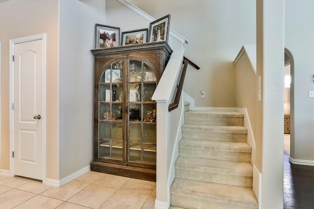 staircase featuring tile patterned flooring