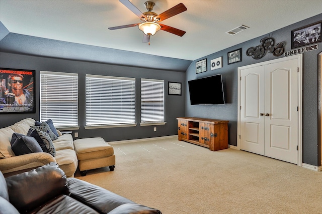 living room with light colored carpet, vaulted ceiling, and ceiling fan