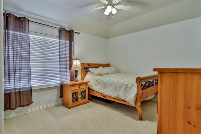 carpeted bedroom with ceiling fan and lofted ceiling