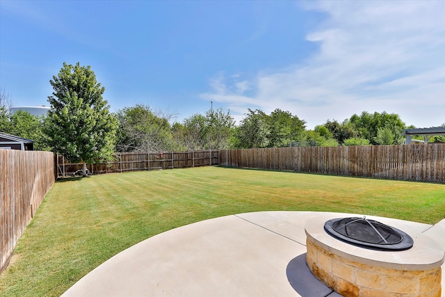 view of yard with an outdoor fire pit and a patio