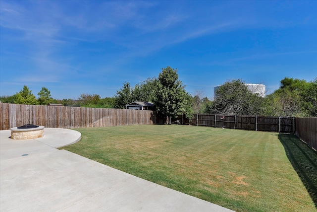 view of yard featuring a patio and a fire pit