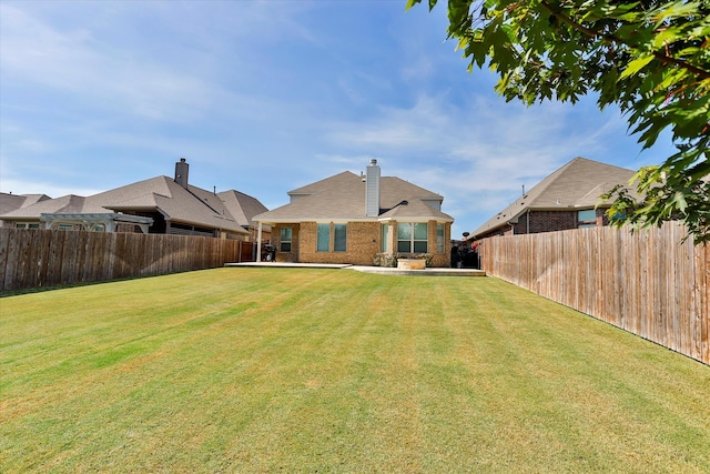 back of house featuring a yard