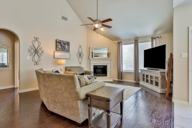 living room with high vaulted ceiling, ceiling fan, and dark wood-type flooring