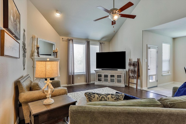 living room with ceiling fan, light hardwood / wood-style flooring, and lofted ceiling