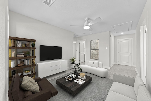 living area featuring attic access, baseboards, visible vents, ceiling fan, and carpet flooring