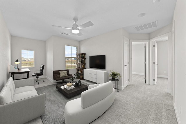 living area with plenty of natural light, carpet flooring, and visible vents