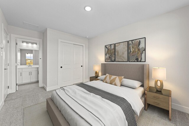 bedroom featuring visible vents, baseboards, connected bathroom, light colored carpet, and a closet