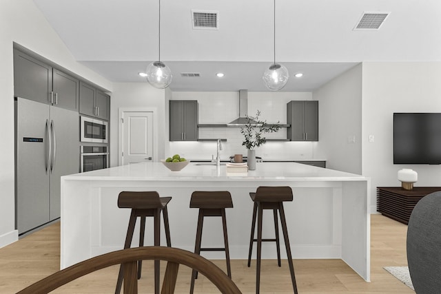 kitchen featuring stainless steel appliances, visible vents, and a sink