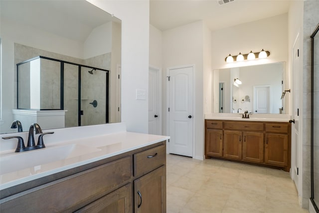 bathroom with vanity and a shower with door