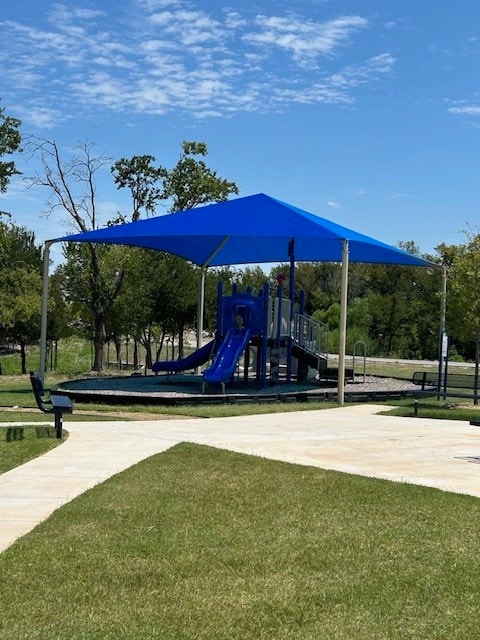 view of playground with a lawn