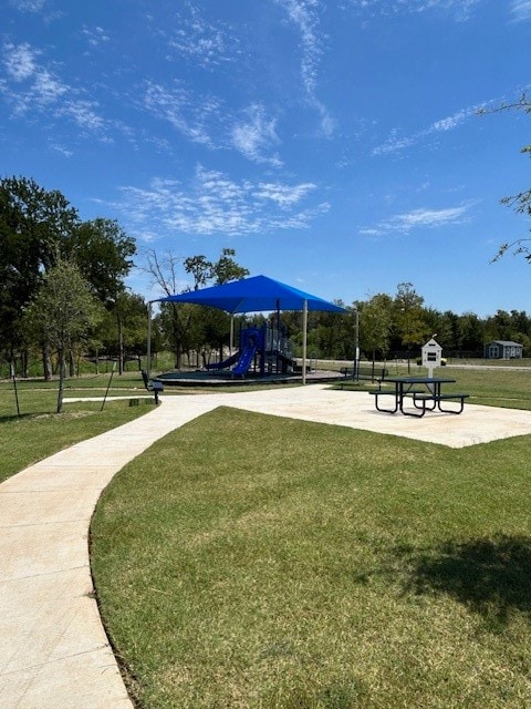 view of community with a yard and a playground