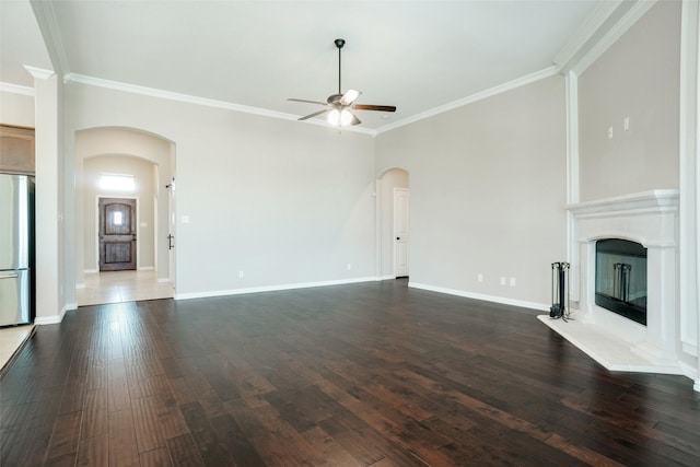 unfurnished living room with ceiling fan, crown molding, and dark hardwood / wood-style flooring