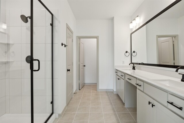 bathroom featuring tile patterned flooring, vanity, and walk in shower