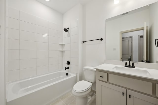 full bathroom featuring tile patterned floors, tiled shower / bath combo, toilet, and vanity