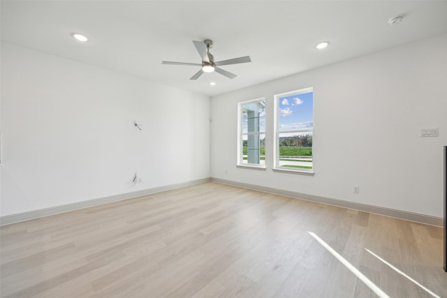 spare room featuring light wood-type flooring and ceiling fan