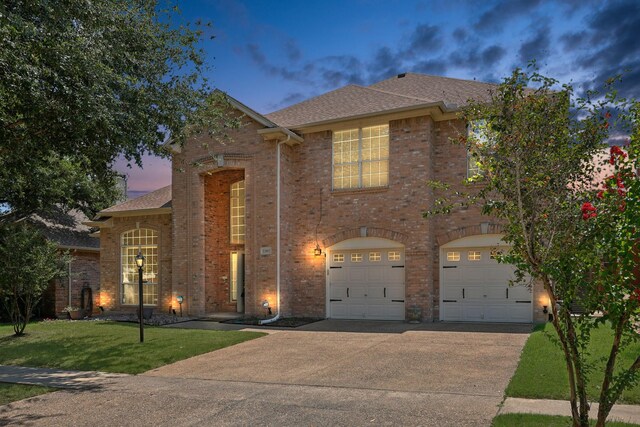 view of front of property featuring a yard and a garage