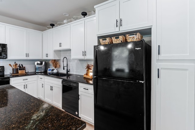 kitchen with decorative backsplash, white cabinets, a sink, and black appliances