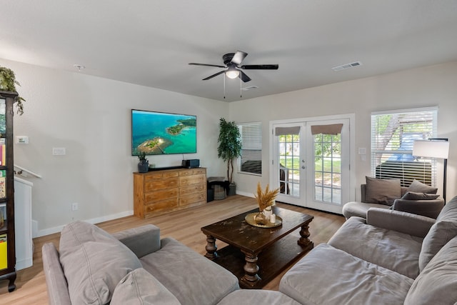 living room with ceiling fan, french doors, and light hardwood / wood-style floors