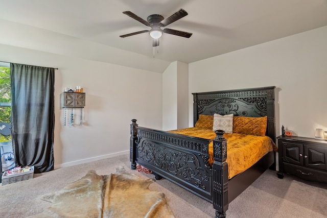 carpeted bedroom with ceiling fan and baseboards