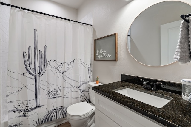 bathroom featuring a textured wall, a shower with shower curtain, vanity, and toilet