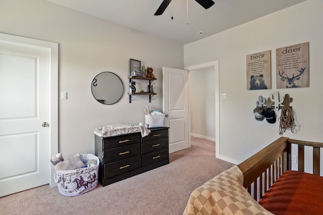 bedroom with ceiling fan, baseboards, and light colored carpet