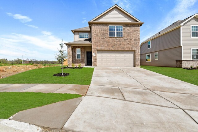 view of front facade with a front yard and a garage