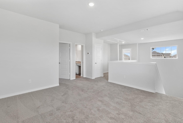 empty room featuring carpet floors, recessed lighting, visible vents, and baseboards