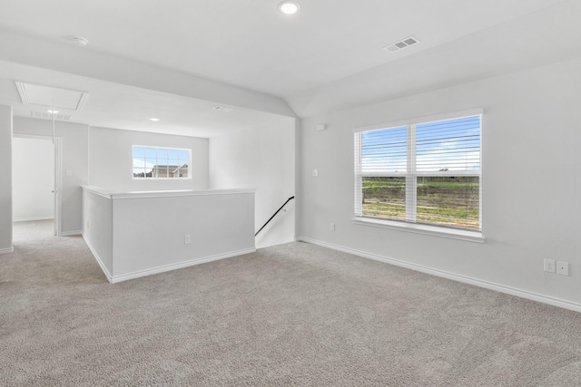 carpeted empty room with attic access, recessed lighting, visible vents, and baseboards