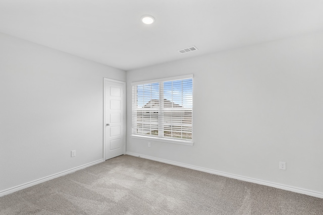 spare room featuring light colored carpet